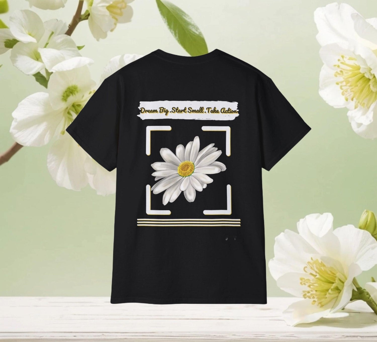 Black unisex t-shirt with a chamomile floral DreamBig Start Small Take Action front and back with white flowers background by Youniqverse